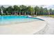 Community pool with zero entry access, sun loungers, and palm trees, offering a resort-style experience at 575 Red Monarch Way, Moncks Corner, SC 29461