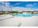 Community pool area featuring a zero entry point, lounge chairs, and shady palm trees at 575 Red Monarch Way, Moncks Corner, SC 29461