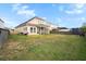 Expansive backyard with well-maintained lawn, screened porch, and full fence at 589 Crossland Dr, Moncks Corner, SC 29461