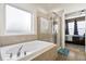 Bathroom including a standalone bathtub and a glass-enclosed shower at 589 Crossland Dr, Moncks Corner, SC 29461