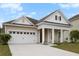 Beautiful home with a two car garage, covered porch, and manicured lawn at 589 Crossland Dr, Moncks Corner, SC 29461