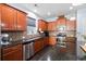 Well-equipped kitchen with stainless steel appliances, brown cabinets, and dark granite countertops at 589 Crossland Dr, Moncks Corner, SC 29461