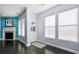 Inviting living room featuring a fireplace, three large windows and dark wood flooring at 589 Crossland Dr, Moncks Corner, SC 29461