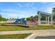 Community playground with picnic area and pool in background at 589 Crossland Dr, Moncks Corner, SC 29461