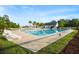 Community swimming pool with ladder, lounge chairs, clubhouse and palm trees at 589 Crossland Dr, Moncks Corner, SC 29461