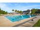 Community swimming pool with ladder, lounge chairs, clubhouse and palm trees at 589 Crossland Dr, Moncks Corner, SC 29461