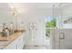 Bathroom featuring marble tile, a glass shower, and double vanity, blending luxury and functionality at 62 Gadsden St # A, Charleston, SC 29401