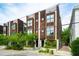 Street view of modern townhomes boasting wood facades and lush landscaping, enhancing curb appeal at 62 Gadsden St # A, Charleston, SC 29401
