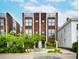 Stunning modern townhome with a wood facade, private rooftop terrace, and professionally landscaped entryway at 62 Gadsden St # A, Charleston, SC 29401