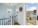 Light-filled hallway with view to outdoor space that includes a 'Happy Place' sign and potted greenery at 62 Gadsden St # A, Charleston, SC 29401