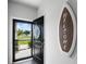 Inviting entryway with a surfboard welcome sign, and a black front door open to an outdoor view at 655 Jancus St, Charleston, SC 29414