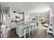 Open-concept kitchen with a granite island, stainless steel appliances, and a view into the living area at 655 Jancus St, Charleston, SC 29414