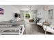 Inviting living room featuring a gray sofa, rattan accents, light hardwood floors, and natural light at 655 Jancus St, Charleston, SC 29414