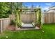 Backyard with wooden swing set and green grass and partial wooden fence at 655 Jancus St, Charleston, SC 29414
