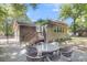 Charming backyard features a brick patio with outdoor seating and a well-maintained lawn at 679 Edmonds Dr, Charleston, SC 29412