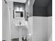 Stylish bathroom featuring a pedestal sink, tiled walls, and modern fixtures at 679 Edmonds Dr, Charleston, SC 29412