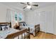 bedroom with twin beds, wooden frames, a ceiling fan, and lots of natural light at 679 Edmonds Dr, Charleston, SC 29412