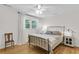 Bright bedroom with hardwood floors, natural light, and a comfortable wrought iron bed frame at 679 Edmonds Dr, Charleston, SC 29412