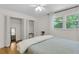 Well-lit bedroom featuring hardwood floors, a ceiling fan, and closet space at 679 Edmonds Dr, Charleston, SC 29412