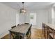 Dining area showcasing a rustic table with views through the kitchen and out a sunlit window at 679 Edmonds Dr, Charleston, SC 29412