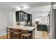 Open kitchen with stainless steel appliances, a peninsula countertop, and dark cabinets, perfect for entertaining at 679 Edmonds Dr, Charleston, SC 29412