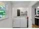 Laundry room with modern washer and dryer, a window, and a white shelf above appliances at 679 Edmonds Dr, Charleston, SC 29412