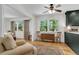 Bright living room featuring ample natural light, hardwood flooring, and a stylish ceiling fan at 679 Edmonds Dr, Charleston, SC 29412