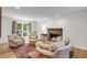 Comfortable living room featuring a cozy fireplace, hardwood floors, and large windows at 679 Edmonds Dr, Charleston, SC 29412