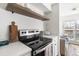 Updated kitchen features stainless appliances, quartz countertops, and open shelving at 700 Daniel Ellis Drive # 5303, James Island, SC 29412