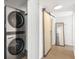 A full size washer/dryer sits next to a wood sliding barn door with full length mirror at 700 Daniel Ellis Drive # 5303, James Island, SC 29412