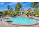 Community pool with brick trim, lounge chairs, palm trees, and lush landscaping at 700 Daniel Ellis Drive # 5303, James Island, SC 29412