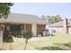 Home's backyard featuring a newly planted tree, patio and grass at 7712 Corley Dr, North Charleston, SC 29418