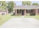 A beautiful home with a well-manicured lawn and a paved driveway at 7712 Corley Dr, North Charleston, SC 29418
