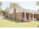 Lovely brick home featuring a well-maintained lawn and a classic chimney at 7712 Corley Dr, North Charleston, SC 29418