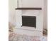 White-painted brick fireplace with a dark wood mantel and metal screen adds charm to the living area at 7712 Corley Dr, North Charleston, SC 29418