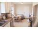 Bright kitchen featuring white cabinets, stainless steel appliances, and an adjacent dining area at 7712 Corley Dr, North Charleston, SC 29418