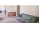 Cozy living room with gray sofa, decorative pillow and rattan cabinet on tile floor at 7712 Corley Dr, North Charleston, SC 29418