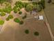 Aerial view of a home and outbuildings surrounded by a white fence at 7875 Berry Manor Ln, Edisto Island, SC 29438