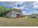 Home's backyard featuring a deck, landscaping, and a separate storage building at 7875 Berry Manor Ln, Edisto Island, SC 29438