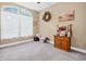 Bright room with a large window, neutral walls, and a cabinet displaying various items at 7875 Berry Manor Ln, Edisto Island, SC 29438