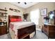 Cozy bedroom with wood furnishings, decorative accents, and natural light through the window at 7875 Berry Manor Ln, Edisto Island, SC 29438