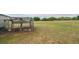Chicken coop on a spacious lot with white fencing in the distance at 7875 Berry Manor Ln, Edisto Island, SC 29438