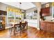 Dining area with hardwood floors, a custom stained-glass window and backyard views at 7875 Berry Manor Ln, Edisto Island, SC 29438