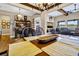 Spacious dining area with wood beams, a farmhouse table, and views to the living room at 7875 Berry Manor Ln, Edisto Island, SC 29438