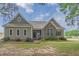 Charming home featuring a combination of stone and siding, complemented by lush landscaping at 7875 Berry Manor Ln, Edisto Island, SC 29438