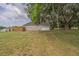 House featuring a garage and an outdoor fenced area surrounded by large trees at 7875 Berry Manor Ln, Edisto Island, SC 29438