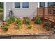 Charming flower garden alongside the house with a variety of blooming roses and mulch at 7875 Berry Manor Ln, Edisto Island, SC 29438