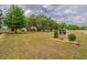 Expansive front yard with mature trees and Rockin H Farm sign in front of home with white picket fence at 7875 Berry Manor Ln, Edisto Island, SC 29438