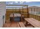 An inviting private deck with a picnic table leads to a hot tub fenced with lattice at 7875 Berry Manor Ln, Edisto Island, SC 29438