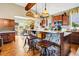 Open-concept kitchen with stone island, pendant lights, and stainless steel appliances at 7875 Berry Manor Ln, Edisto Island, SC 29438